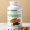 Capsule de Curcuma BIO + Piperine BIO de Nutrinature, bouteille blanche avec étiquette verte et images de curcuma et poivre noir.